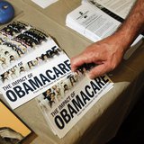 A Tea Party member reaches for a pamphlet titled "The Impact of Obamacare" in Littleton, New Hampshire October 27, 2012. REUTERS/Jessica Rin A Tea Party member reaches for a pamphlet titled "The Impact of Obamacare" in Littleton, New Hampshire October 27, 2012. REUTERS/Jessica Rin