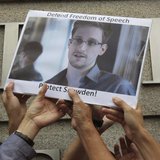 Protesters supporting Edward Snowden, a contractor at the National Security Agency (NSA), hold a photo of Snowden during a demonstration out