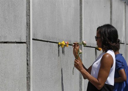 U.S. first lady Michelle Obama (L) and her daughter Sasha place flowers as they visit the Berlin Wall memorial in Bernauer Strasse in Berlin U.S. first lady Michelle Obama (L) and her daughter Sasha place flowers as they visit the Berlin Wall memorial in Bernauer Strasse in Berlin