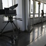 Employees stand by the windows inside the Greek state television ERT headquarters at Aghia Paraskevi suburb in Athens June 18, 2013. REUTERS Employees stand by the windows inside the Greek state television ERT headquarters at Aghia Paraskevi suburb in Athens June 18, 2013. REUTERS