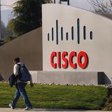 A pedestrian walks past the Cisco logo at the technology company's campus in San Jose, California February 3, 2010. REUTERS/Robert Galbraith A pedestrian walks past the Cisco logo at the technology company's campus in San Jose, California February 3, 2010. REUTERS/Robert Galbraith