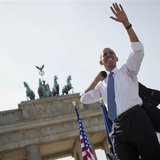 German Chancellor Angela Merkel watches as U.S. President Barack Obama waves after giving a speech in front of the Brandenburg Gate in Berli German Chancellor Angela Merkel watches as U.S. President Barack Obama waves after giving a speech in front of the Brandenburg Gate in Berli