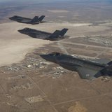 Three F-35 Joint Strike Fighters (rear to front) AF-2, AF-3 and AF-4, can be seen flying over Edwards Air Force Base in this December 10, 20