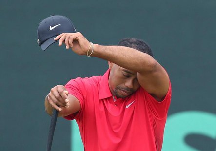 Tiger Woods of the U.S. wipes his face while on the second green during the final round of the 2013 U.S. Open golf championship at the Merio Tiger Woods of the U.S. wipes his face while on the second green during the final round of the 2013 U.S. Open golf championship at the Merio