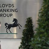 A pedestrian passes the head office of Lloyds Banking Group in central London April 11, 2011. REUTERS/Stefan Wermuth