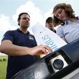 Michael Niesen (2nd L) of MAVinci explains the camera equipped "Sirius" unmanned aerial vehicle (UAV) during a training session for clients Michael Niesen (2nd L) of MAVinci explains the camera equipped "Sirius" unmanned aerial vehicle (UAV) during a training session for clients