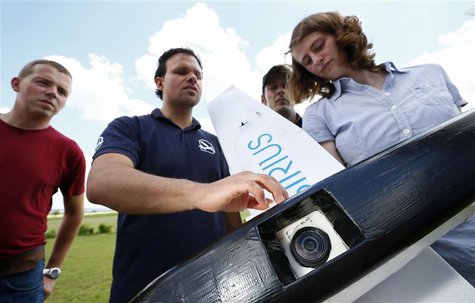 Michael Niesen (2nd L) of MAVinci explains the camera equipped "Sirius" unmanned aerial vehicle (UAV) during a training session for clients Michael Niesen (2nd L) of MAVinci explains the camera equipped "Sirius" unmanned aerial vehicle (UAV) during a training session for clients