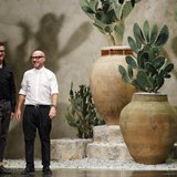 Italian designers Domenico Dolce (R) and Stefano Gabbana acknowledge the audience at the end of their Spring/Summer 2013 collection at Milan