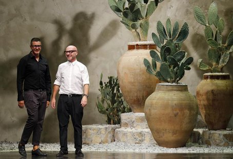Italian designers Domenico Dolce (R) and Stefano Gabbana acknowledge the audience at the end of their Spring/Summer 2013 collection at Milan Italian designers Domenico Dolce (R) and Stefano Gabbana acknowledge the audience at the end of their Spring/Summer 2013 collection at Milan