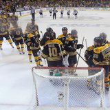 Boston Bruins goalie Tuukka Rask (40) is congratulated by hs teammates after shutting-out the Chicago Blackhawks in Game 3 of their NHL Stan