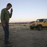 Chris Simcox, president of the Minuteman Civil Defense Corps, listens to a volunteer's radio transmission on the scout line 23 miles north o