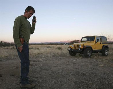 Chris Simcox, president of the Minuteman Civil Defense Corps, listens to a volunteer's radio transmission on the scout line 23 miles north o Chris Simcox, president of the Minuteman Civil Defense Corps, listens to a volunteer's radio transmission on the scout line 23 miles north o