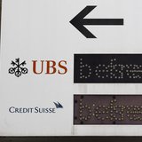 The logos of Swiss banks UBS and Credit Suisse are seen on a sign in Zurich, February 13, 2013. REUTERS/Michael Buholzer The logos of Swiss banks UBS and Credit Suisse are seen on a sign in Zurich, February 13, 2013. REUTERS/Michael Buholzer