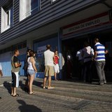 People wait to enter a government job centre in Madrid August 2, 2010. REUTERS/Susana Vera