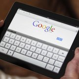An illustration picture shows a woman holding her Apple Ipad tablet which displays a tactile keyboard under the Google home page in Bordeaux An illustration picture shows a woman holding her Apple Ipad tablet which displays a tactile keyboard under the Google home page in Bordeaux