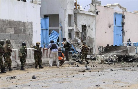 Security agents arrive to secure the United Nations compound following a suicide bomb attack in the capital Mogadishu, June 19, 2013. REUTER Security agents arrive to secure the United Nations compound following a suicide bomb attack in the capital Mogadishu, June 19, 2013. REUTER