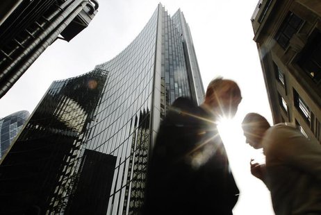 Pedestrians pass office blocks in the City of London June 19, 2013. REUTERS/Luke MacGregor Pedestrians pass office blocks in the City of London June 19, 2013. REUTERS/Luke MacGregor