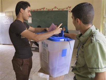 A youth casts his vote into a ballot box during the Iraq's provincial elections at a polling station in Ramadi, 100 km (62 miles) west of Ba A youth casts his vote into a ballot box during the Iraq's provincial elections at a polling station in Ramadi, 100 km (62 miles) west of Ba