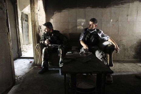 Members of the Free Syrian Army sit on a sofa inside a house in the old city of Aleppo June 19, 2013. REUTERS/Muzaffar Salman Members of the Free Syrian Army sit on a sofa inside a house in the old city of Aleppo June 19, 2013. REUTERS/Muzaffar Salman