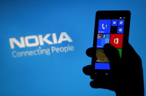A woman poses with a Nokia Lumia smartphone in this photo illustration in the central Bosnian town of Zenica, May 6, 2013. REUTERS/Dado Ruvi A woman poses with a Nokia Lumia smartphone in this photo illustration in the central Bosnian town of Zenica, May 6, 2013. REUTERS/Dado Ruvi