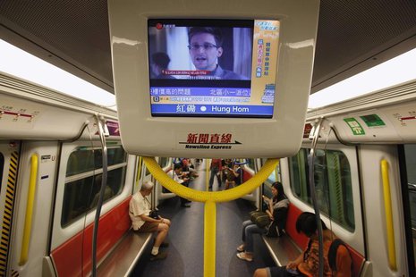 Edward Snowden, a former contractor at the National Security Agency (NSA), is seen during a news broadcast on a screen inside a train in Hon Edward Snowden, a former contractor at the National Security Agency (NSA), is seen during a news broadcast on a screen inside a train in Hon
