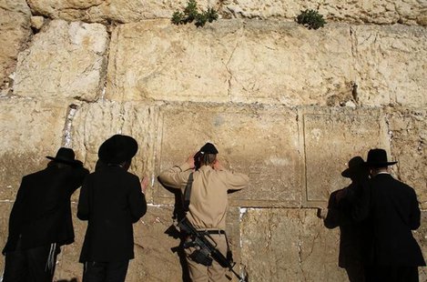 An Israeli soldier touches the Western Wall in Jerusalem's Old City January 21, 2013. REUTERS/Ammar Awad An Israeli soldier touches the Western Wall in Jerusalem's Old City January 21, 2013. REUTERS/Ammar Awad
