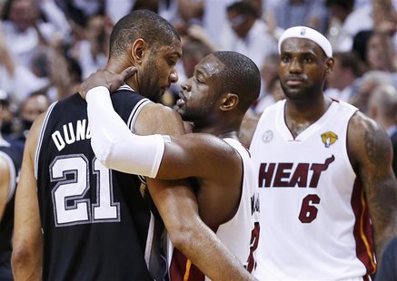 Miami Heat's Dwyane Wade hugs San Antonio Spurs' Tim Duncan (L) as the Heat's LeBron James (R) approaches after the Heat defeated the Spurs Miami Heat's Dwyane Wade hugs San Antonio Spurs' Tim Duncan (L) as the Heat's LeBron James (R) approaches after the Heat defeated the Spurs