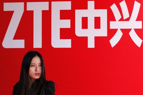 A woman stands in front of a ZTE company logo during the company's 15th anniversary celebration in Beijing April 18, 2013. REUTERS/Barry Hua A woman stands in front of a ZTE company logo during the company's 15th anniversary celebration in Beijing April 18, 2013. REUTERS/Barry Hua
