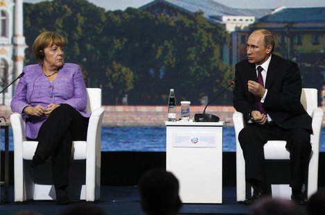 Russia's President Vladimir Putin (R) and Germany's Chancellor Angela Merkel attend a session of the St. Petersburg International Economic F Russia's President Vladimir Putin (R) and Germany's Chancellor Angela Merkel attend a session of the St. Petersburg International Economic F