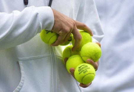 Balls marked Wimbledon 2013 are held during a training session before the Queen's Club Championships in west London June 10, 2013. REUTERS/T Balls marked Wimbledon 2013 are held during a training session before the Queen's Club Championships in west London June 10, 2013. REUTERS/T