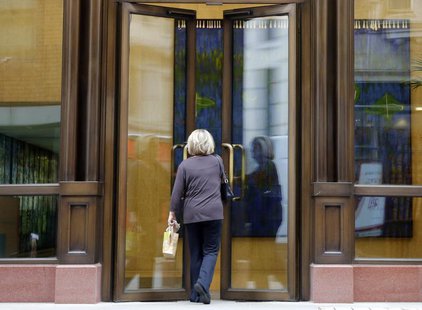 A woman enters the offices of private equity firm APAX in London May 18, 2012. REUTERS/Chris Helgren A woman enters the offices of private equity firm APAX in London May 18, 2012. REUTERS/Chris Helgren