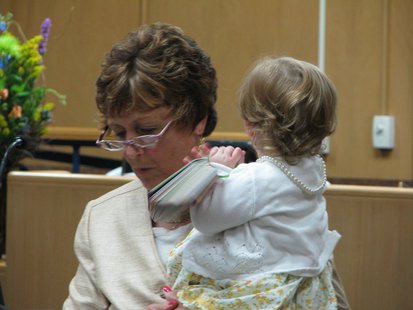Wife and Wausau City Attorney Anne Jacobson speaks during her husband's ceremony, with help from their granddaughter. Wife and Wausau City Attorney Anne Jacobson speaks during her husband's ceremony, with help from their granddaughter.