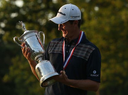 England's Justin Rose looks at the U.S. Open Trophy after winning the 2013 U.S. Open golf championship at the Merion Golf Club in Ardmore, P England's Justin Rose looks at the U.S. Open Trophy after winning the 2013 U.S. Open golf championship at the Merion Golf Club in Ardmore, P