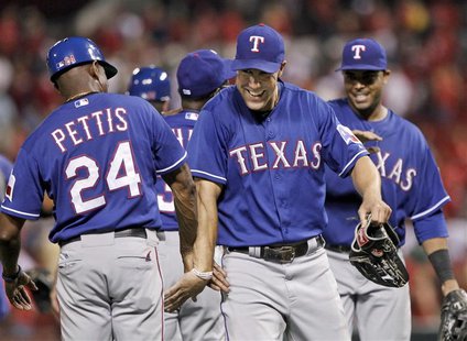 Texas Rangers left fielder David Murphy celebrates with third base coach Gary Pettis (L) after beating the St. Louis Cardinals 6-4 in their Texas Rangers left fielder David Murphy celebrates with third base coach Gary Pettis (L) after beating the St. Louis Cardinals 6-4 in their