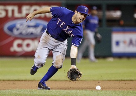 Texas Rangers second baseman Ian Kinsler fields a ball hit by St. Louis Cardinals second baseman Matt Carpenter during the eighth inning of Texas Rangers second baseman Ian Kinsler fields a ball hit by St. Louis Cardinals second baseman Matt Carpenter during the eighth inning of