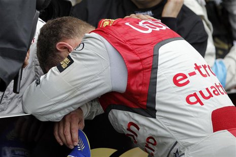 Audi R18 E-Tron Quattro Number 2 driver Tom Kristensen observes a moment of silence as he pays homage to his compatriot Allan Simonsen after Audi R18 E-Tron Quattro Number 2 driver Tom Kristensen observes a moment of silence as he pays homage to his compatriot Allan Simonsen after