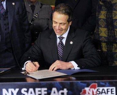 New York Governor Andrew Cuomo signs the New York Secure Ammunition and Firearms Enforcement Act at the Capitol in Albany, New York January New York Governor Andrew Cuomo signs the New York Secure Ammunition and Firearms Enforcement Act at the Capitol in Albany, New York January