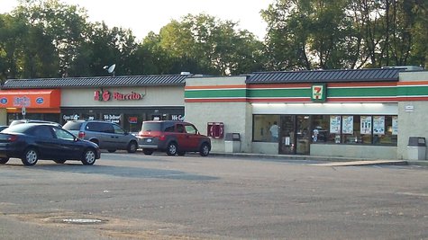 The 7-11 is located in a mini-mall just off Drake Road in an area dominated by student housing. The 7-11 is located in a mini-mall just off Drake Road in an area dominated by student housing.
