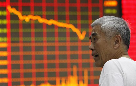 An investor stands in front of an electronic board showing stock information at a brokerage house in Huaibei, Anhui province, June 24, 2013. An investor stands in front of an electronic board showing stock information at a brokerage house in Huaibei, Anhui province, June 24, 2013.
