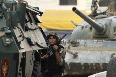A Lebanese Army soldier takes position during clashes in Sidon, southern Lebanon, June 24, 2013. REUTERS/ Ali Hashisho A Lebanese Army soldier takes position during clashes in Sidon, southern Lebanon, June 24, 2013. REUTERS/ Ali Hashisho