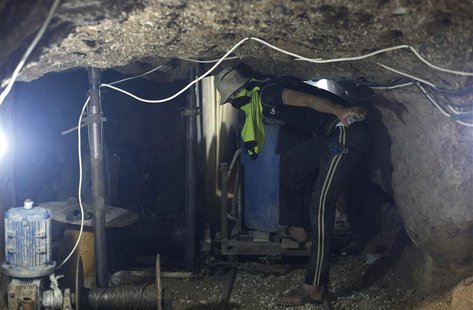 A Palestinian man brings gravels as he works inside a smuggling tunnel beneath the Gaza-Egypt border in Rafah in the southern Gaza Strip Jun A Palestinian man brings gravels as he works inside a smuggling tunnel beneath the Gaza-Egypt border in Rafah in the southern Gaza Strip Jun