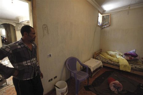 A man enters the room of a house, where four Egyptian Shi'ites were killed, in the suburb of Zawiyat Abu Musallem, on the outskirts of Cairo A man enters the room of a house, where four Egyptian Shi'ites were killed, in the suburb of Zawiyat Abu Musallem, on the outskirts of Cairo