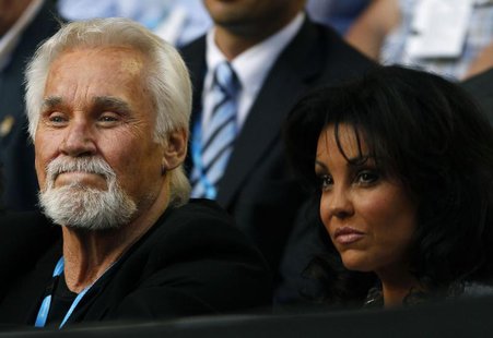 Singer Kenny Rogers and his wife Wanda Miller watch the match between Rafael Nadal of Spain and Marin Cilic of Croatia at the Australian Ope Singer Kenny Rogers and his wife Wanda Miller watch the match between Rafael Nadal of Spain and Marin Cilic of Croatia at the Australian Ope