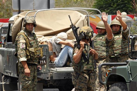Lebanese army soldiers gesture as they capture a gunmen in Sidon, southern Lebanon, June 24, 2013. REUTERS/Ali Hashisho Lebanese army soldiers gesture as they capture a gunmen in Sidon, southern Lebanon, June 24, 2013. REUTERS/Ali Hashisho