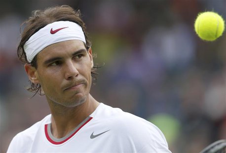 Rafael Nadal of Spain reacts during his men's singles tennis match against Steve Darcis of Belgium at the Wimbledon Tennis Championships, in Rafael Nadal of Spain reacts during his men's singles tennis match against Steve Darcis of Belgium at the Wimbledon Tennis Championships, in