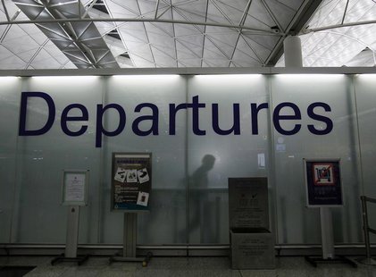 A passenger walks to an immigration counter after entering the restricted area of the departure hall at Hong Kong Airport June 23, 2013. Edw A passenger walks to an immigration counter after entering the restricted area of the departure hall at Hong Kong Airport June 23, 2013. Edw