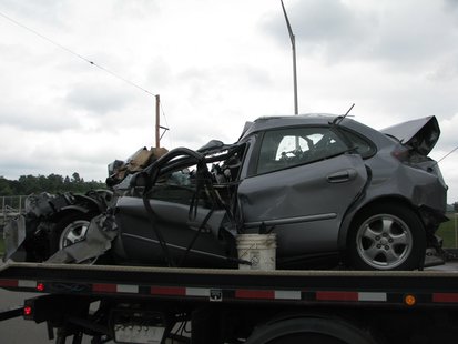 This was a Ford Taurus. The 85-year-old driver died from the injuries after being struck in the rear and shoved into a truck in front of her. This was a Ford Taurus. The 85-year-old driver died from the injuries after being struck in the rear and shoved into a truck in front of her.