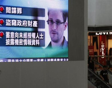 A monitor broadcasts news on the charges against Edward Snowden, a former contractor at the National Security Agency (NSA), by the United St A monitor broadcasts news on the charges against Edward Snowden, a former contractor at the National Security Agency (NSA), by the United St