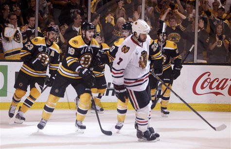 Boston Bruins Chris Kelly (23) skates off with teammates Tyler Seguin (19) and Daniel Paille (20) behind Chicago Blackhawks Brent Seabrook ( Boston Bruins Chris Kelly (23) skates off with teammates Tyler Seguin (19) and Daniel Paille (20) behind Chicago Blackhawks Brent Seabrook (