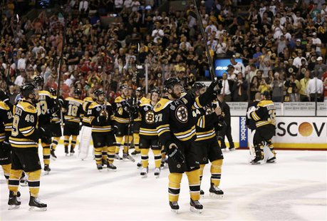 Boston Bruins' Patrice Bergeron (C) leads his team in saluting the crowd after losing to the Chicago Blackhawks in Game 6 of their NHL Stanl Boston Bruins' Patrice Bergeron (C) leads his team in saluting the crowd after losing to the Chicago Blackhawks in Game 6 of their NHL Stanl